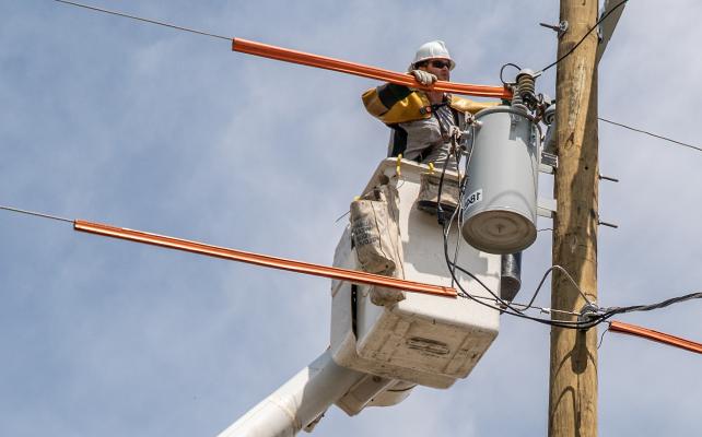 A Sempra lineman fixing a power line